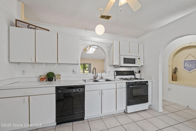 2719 Alicia Ln, Melbourne, FL 32935 - kitchen with black dishwasher, range with gas stovetop, white microwave, a sink, and arched walkways