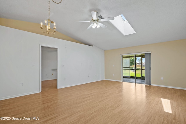 2719 Alicia Ln, Melbourne, FL 32935 - unfurnished room with lofted ceiling, a skylight, light wood finished floors, a ceiling fan, and a chandelier