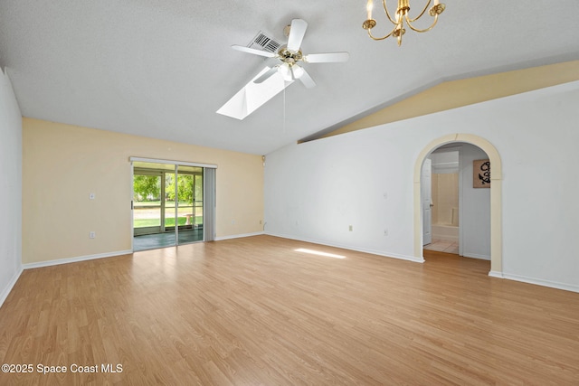 2719 Alicia Ln, Melbourne, FL 32935 - spare room featuring lofted ceiling, light wood-style floors, ceiling fan, a skylight, and baseboards