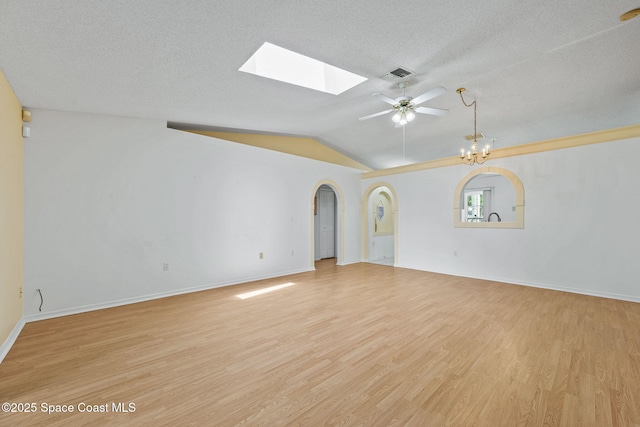 2719 Alicia Ln, Melbourne, FL 32935 - spare room featuring ceiling fan, light wood-style flooring, a skylight, baseboards, and vaulted ceiling