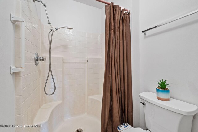 2719 Alicia Ln, Melbourne, FL 32935 - bathroom featuring tiled shower and toilet