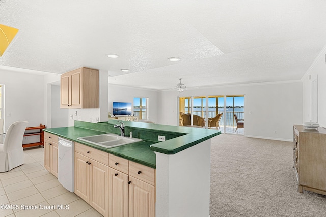 104 Riverside Dr Unit 301, Cocoa, FL 32922 - kitchen featuring a sink, dishwasher, dark countertops, light brown cabinets, and open floor plan