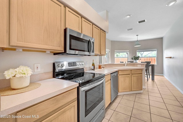 1745 Curlew Ct, Rockledge, FL 32955 - kitchen featuring appliances with stainless steel finishes, light brown cabinetry, light tile patterned floors, light countertops, and a sink