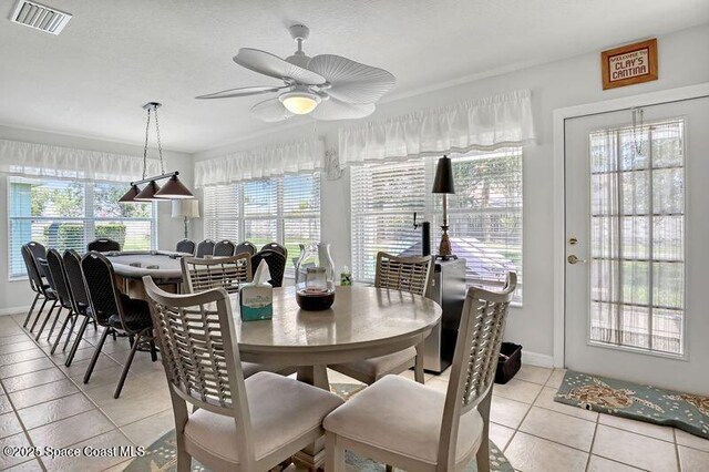 1545 Boca Rio Dr, Melbourne, FL 32940 - dining room with light tile patterned flooring, ceiling fan, and baseboards