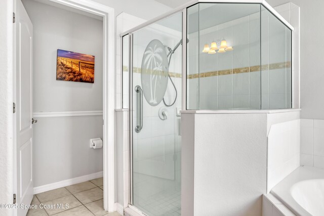 1545 Boca Rio Dr, Melbourne, FL 32940 - bathroom featuring a shower stall, a bath, and tile patterned flooring