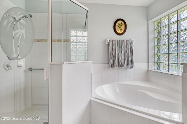1545 Boca Rio Dr, Melbourne, FL 32940 - full bath featuring plenty of natural light, a garden tub, and a tile shower