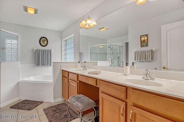 1545 Boca Rio Dr, Melbourne, FL 32940 - full bathroom featuring tile patterned flooring, a bath, double vanity, a shower stall, and baseboards
