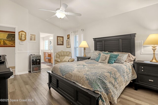 1545 Boca Rio Dr, Melbourne, FL 32940 - bedroom with beverage cooler, light wood finished floors, lofted ceiling, ceiling fan, and ensuite bath