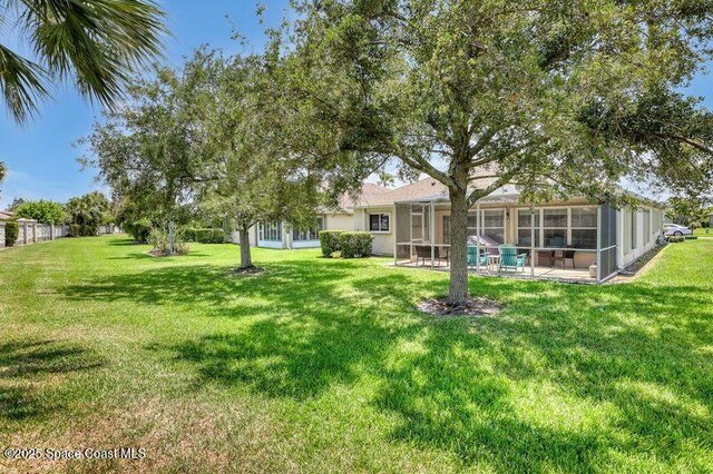 1545 Boca Rio Dr, Melbourne, FL 32940 - view of green lawn with a patio