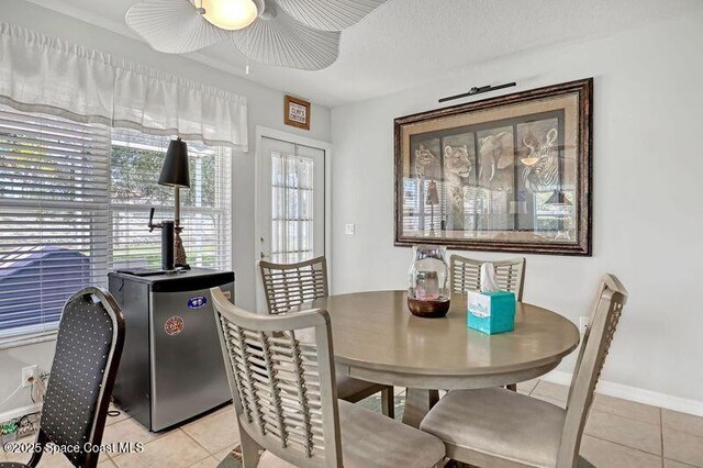 1545 Boca Rio Dr, Melbourne, FL 32940 - dining area featuring light tile patterned flooring, a ceiling fan, and baseboards
