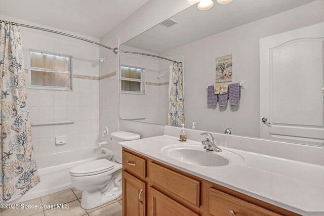 1545 Boca Rio Dr, Melbourne, FL 32940 - bathroom with vanity, shower / bath combo, toilet, and tile patterned flooring