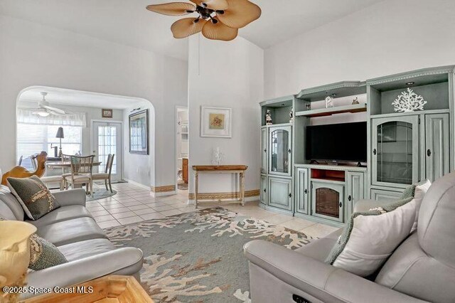 1545 Boca Rio Dr, Melbourne, FL 32940 - living room with a ceiling fan, light tile patterned floors, baseboards, and a high ceiling