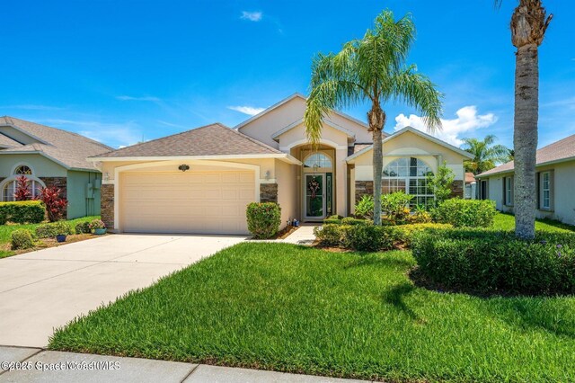 1545 Boca Rio Dr, Melbourne, FL 32940 - ranch-style home featuring stucco siding, a garage, concrete driveway, and a front yard