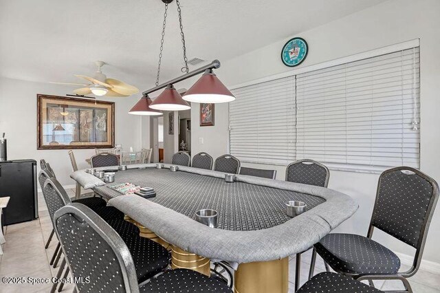 1545 Boca Rio Dr, Melbourne, FL 32940 - dining area with ceiling fan and light tile patterned flooring