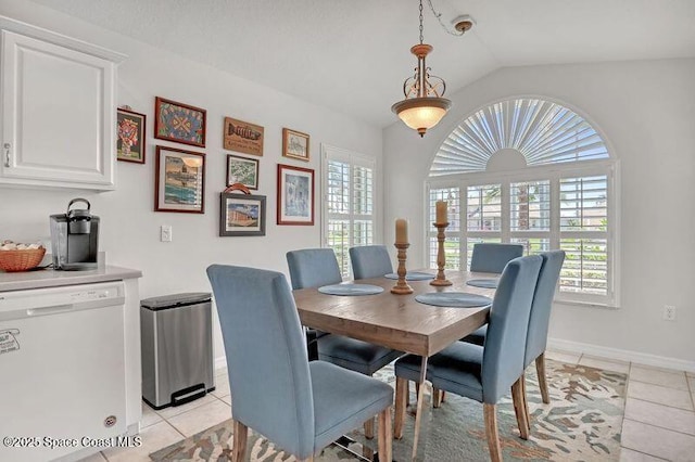 1545 Boca Rio Dr, Melbourne, FL 32940 - dining space featuring light tile patterned flooring, vaulted ceiling, healthy amount of natural light, and baseboards