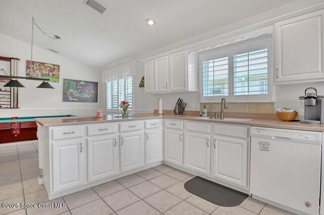 1545 Boca Rio Dr, Melbourne, FL 32940 - kitchen with dishwasher, a sink, vaulted ceiling, light countertops, and light tile patterned flooring