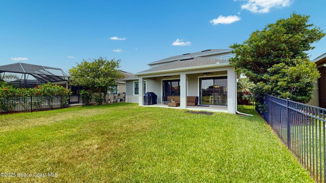 8051 Strom Park Dr, Melbourne, FL 32940 - rear view of house with ceiling fan, stucco siding, a shingled roof, and a patio area