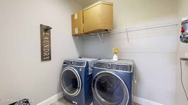 8051 Strom Park Dr, Melbourne, FL 32940 - washroom featuring cabinet space, washing machine and dryer, and baseboards