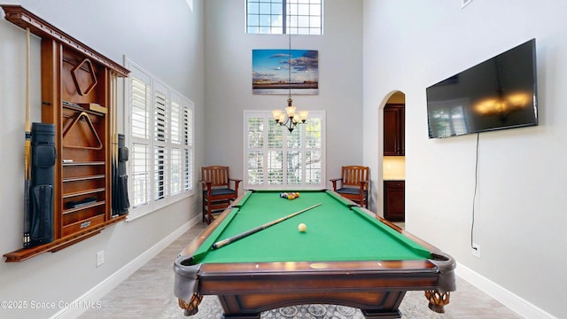 8051 Strom Park Dr, Melbourne, FL 32940 - game room with a towering ceiling, baseboards, arched walkways, and healthy amount of natural light