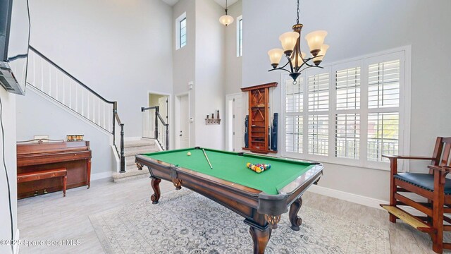 8051 Strom Park Dr, Melbourne, FL 32940 - playroom with a towering ceiling, a chandelier, pool table, and baseboards