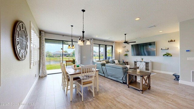 8051 Strom Park Dr, Melbourne, FL 32940 - dining room with baseboards, ceiling fan, light wood-style flooring, recessed lighting, and a textured ceiling