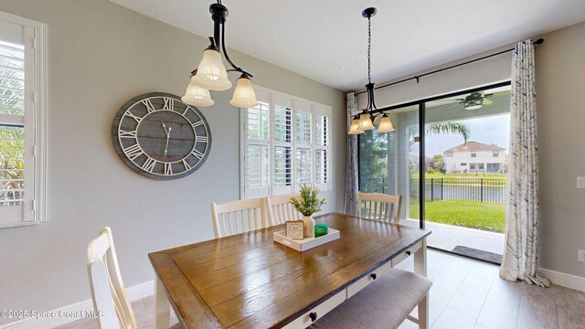 8051 Strom Park Dr, Melbourne, FL 32940 - dining area with baseboards and a chandelier