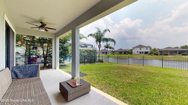 8051 Strom Park Dr, Melbourne, FL 32940 - view of yard with a ceiling fan, a water view, a patio area, and a residential view