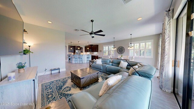 8051 Strom Park Dr, Melbourne, FL 32940 - living room with a ceiling fan, light wood-type flooring, recessed lighting, and baseboards