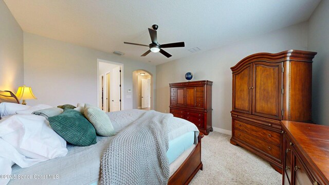 8051 Strom Park Dr, Melbourne, FL 32940 - bedroom featuring light carpet, arched walkways, a ceiling fan, and baseboards