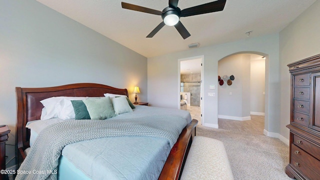 8051 Strom Park Dr, Melbourne, FL 32940 - bedroom with arched walkways, light carpet, baseboards, and ceiling fan