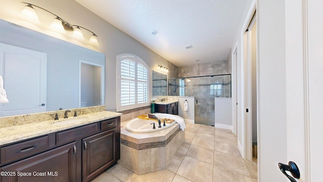 8051 Strom Park Dr, Melbourne, FL 32940 - bathroom featuring a shower stall, two vanities, a bath, and tile patterned flooring