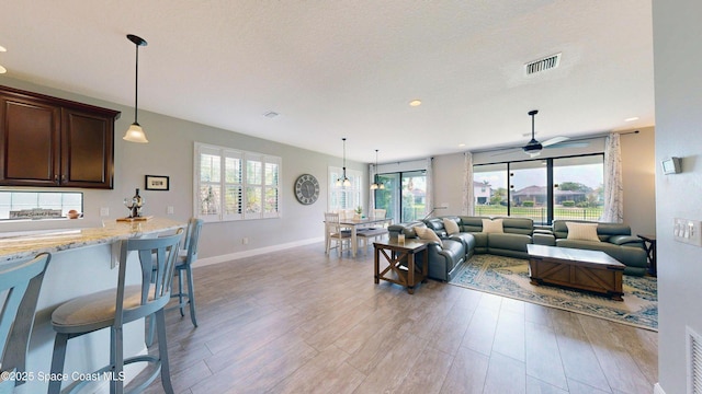 8051 Strom Park Dr, Melbourne, FL 32940 - living area with light wood-type flooring, a ceiling fan, baseboards, and recessed lighting