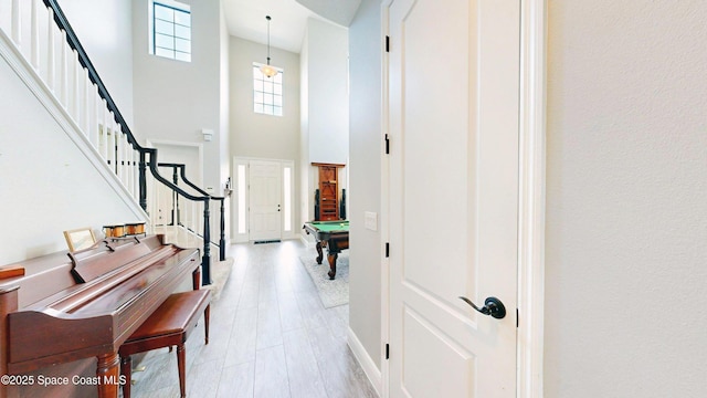 8051 Strom Park Dr, Melbourne, FL 32940 - foyer entrance with billiards, a high ceiling, stairway, and baseboards