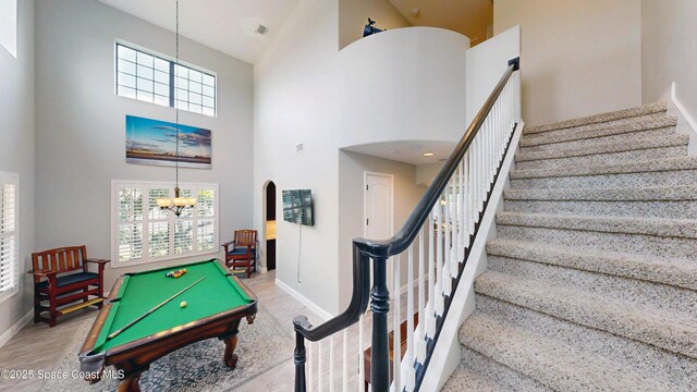 8051 Strom Park Dr, Melbourne, FL 32940 - game room with a towering ceiling, baseboards, a chandelier, wood finished floors, and pool table