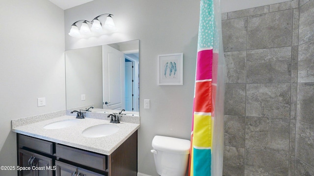8051 Strom Park Dr, Melbourne, FL 32940 - full bathroom featuring double vanity, toilet, and a tile shower