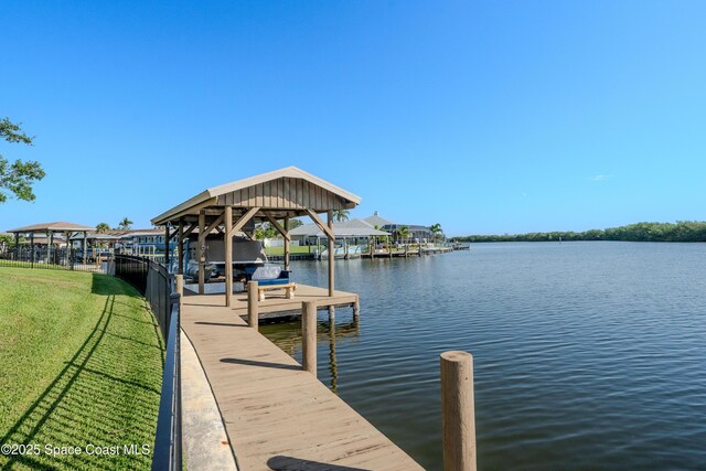 260 Cadiz Ct, Merritt Island, FL 32953 - dock area featuring a water view, boat lift, and a lawn