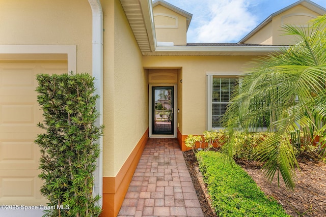 5928 Van Ness Dr, Melbourne, FL 32940 - entrance to property featuring stucco siding and a garage