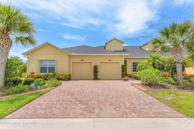 5928 Van Ness Dr, Melbourne, FL 32940 - multi unit property with a garage, decorative driveway, and stucco siding