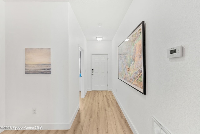 5928 Van Ness Dr, Melbourne, FL 32940 - hallway featuring light wood-style flooring and baseboards