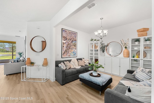 5928 Van Ness Dr, Melbourne, FL 32940 - living room featuring light wood-style floors and a chandelier