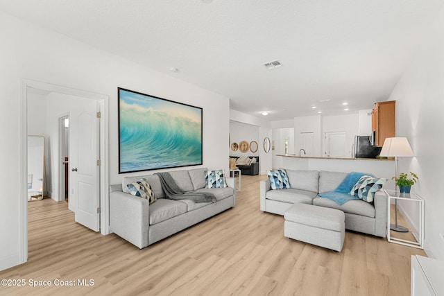 5928 Van Ness Dr, Melbourne, FL 32940 - living room with light wood-style floors, recessed lighting, and baseboards