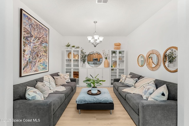 5928 Van Ness Dr, Melbourne, FL 32940 - living area with a chandelier and light wood finished floors