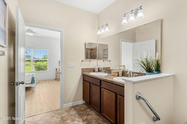 5928 Van Ness Dr, Melbourne, FL 32940 - ensuite bathroom with double vanity, baseboards, and tile patterned flooring