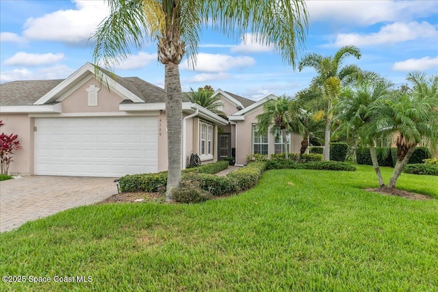 4160 Aberdeen Cir, Rockledge, FL 32955 - ranch-style house with stucco siding, a garage, driveway, and a front lawn