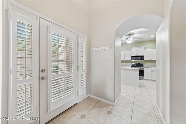 4160 Aberdeen Cir, Rockledge, FL 32955 - doorway with arched walkways, a ceiling fan, light tile patterned floors, and french doors