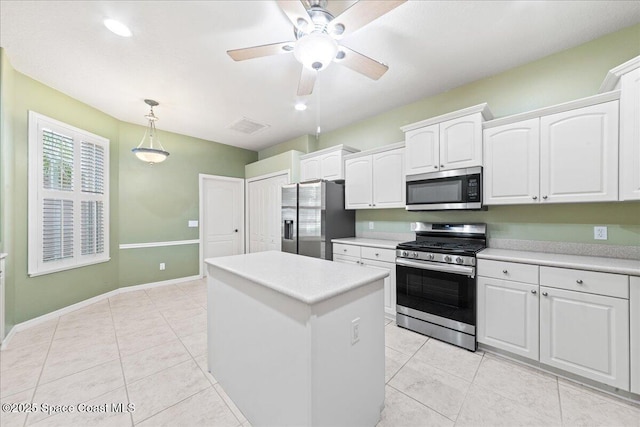 4160 Aberdeen Cir, Rockledge, FL 32955 - kitchen with appliances with stainless steel finishes, white cabinetry, a center island, a ceiling fan, and pendant lighting