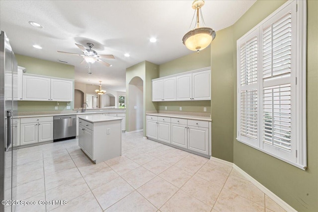 4160 Aberdeen Cir, Rockledge, FL 32955 - kitchen with dishwasher, arched walkways, ceiling fan, light countertops, and white cabinetry