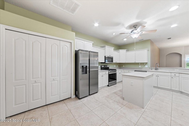 4160 Aberdeen Cir, Rockledge, FL 32955 - kitchen with appliances with stainless steel finishes, light countertops, white cabinets, a kitchen island, and recessed lighting