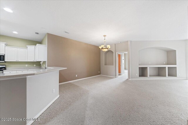 4160 Aberdeen Cir, Rockledge, FL 32955 - kitchen featuring appliances with stainless steel finishes, white cabinets, light colored carpet, light countertops, and a chandelier