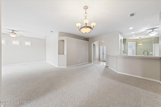 4160 Aberdeen Cir, Rockledge, FL 32955 - carpeted spare room with ceiling fan, arched walkways, and a chandelier